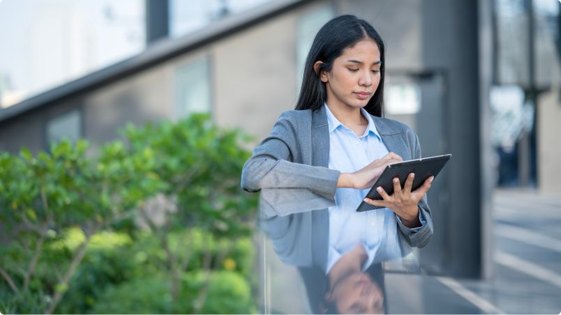 Mulher trabalhando com tablet em ambiente aberto
